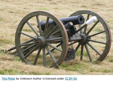 A cannon sitting in the middle of a field.