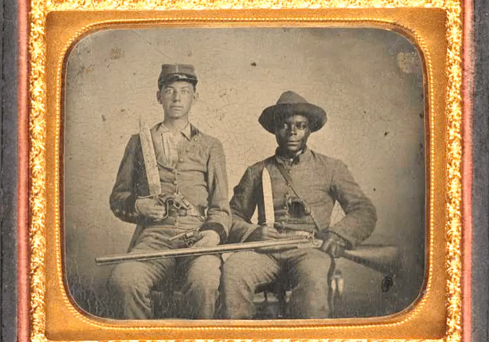 Two men in uniform are posing for a photo.