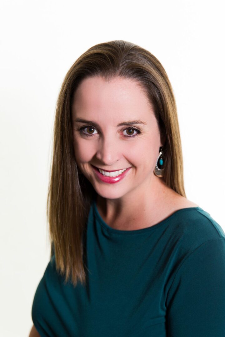 Smiling woman with long brown hair.