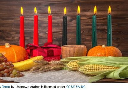 A table with candles and corn on the cob.