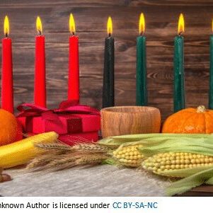 A table with candles and corn on the cob.