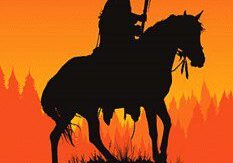 A silhouette of an indian on horseback at sunset.