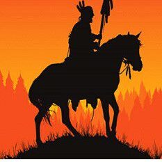 A silhouette of an indian on horseback at sunset.